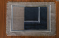 Grey linen placemats with navy blue  linen napkins.
