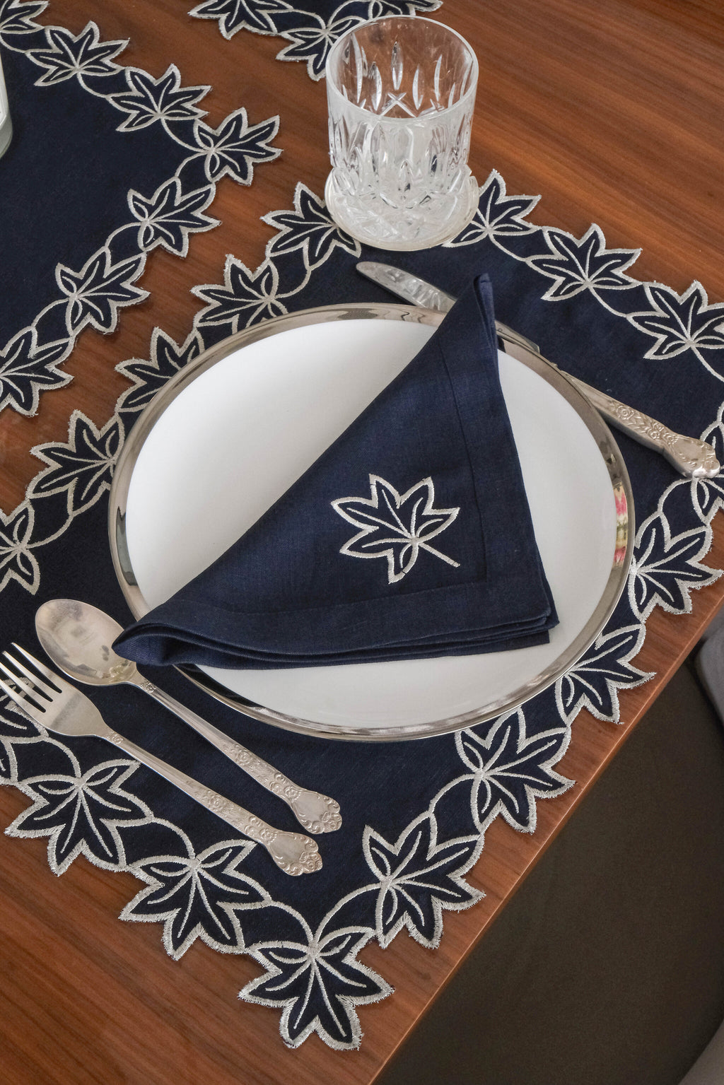 Navy blue linen placemats with  silver embroidered linen napkins.