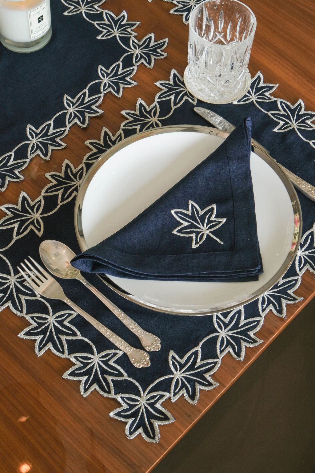 Navy blue linen placemats with  silver embroidered linen napkins.