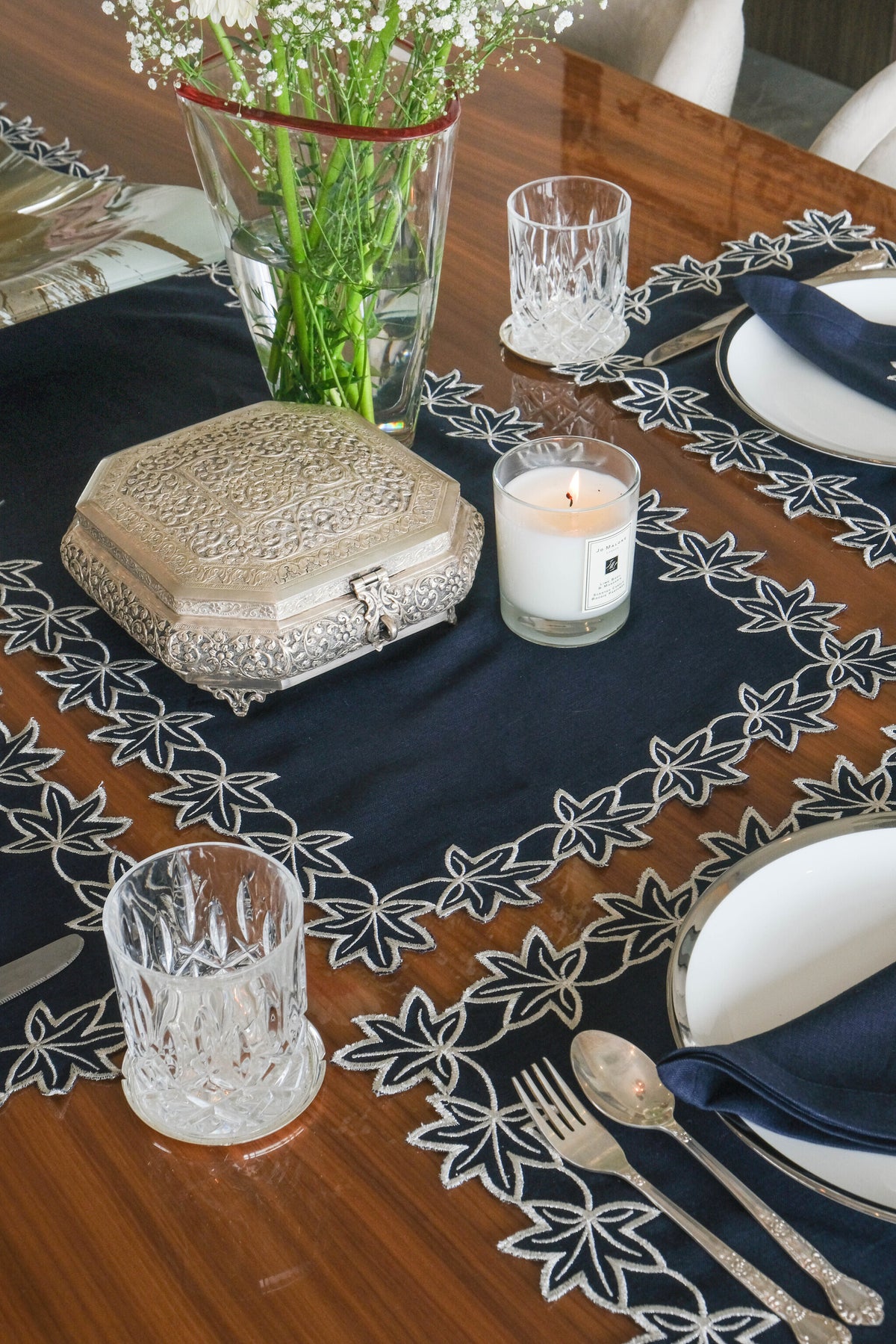 Navy blue linen placemats with  silver embroidered linen napkins.