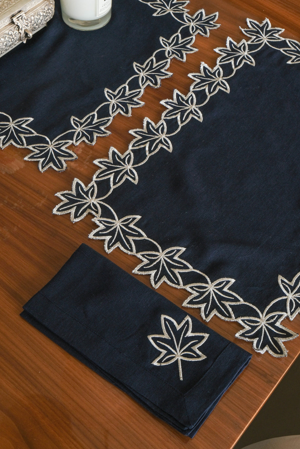Navy blue linen placemats with  silver embroidered linen napkins.