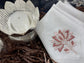 White linen  dinner napkins with lotus embroidery.