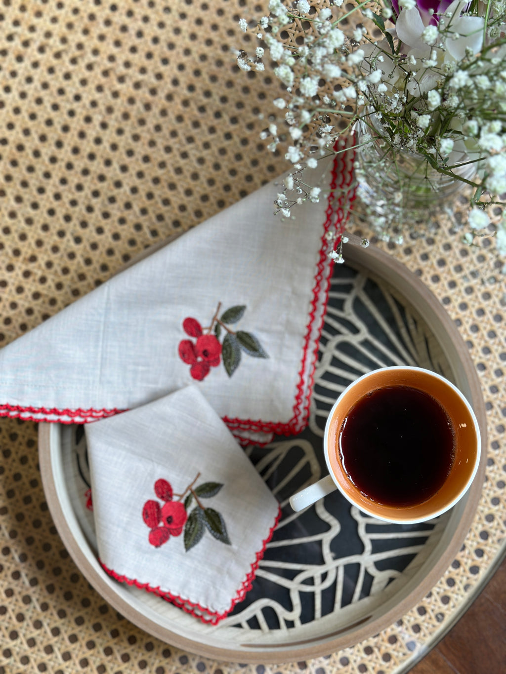 Natural linen cocktail napkins with embroidered cherries.