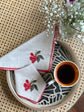 Natural linen cocktail napkins with embroidered cherries.