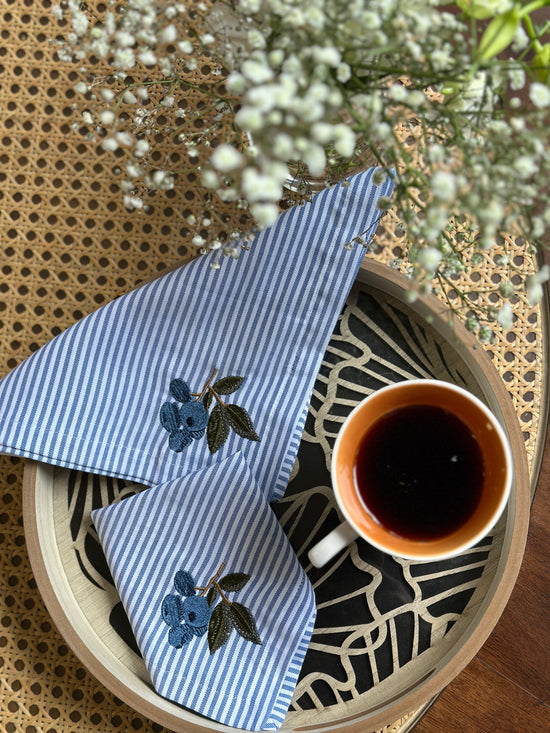 Striped linen cocktail napkin with  embroidered cherries.