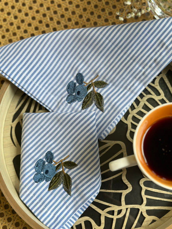 Striped linen cocktail napkin with  embroidered cherries.
