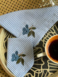 Striped linen cocktail napkin with  embroidered cherries.
