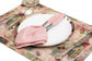 Floral linen printed placemats with pink linen napkins.