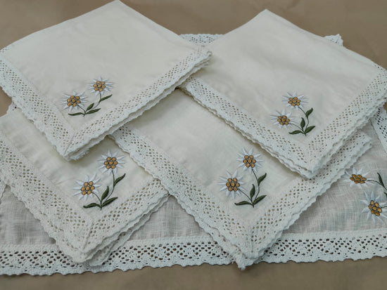 Off white linen placemats and napkins with crochet lace and embroidery.