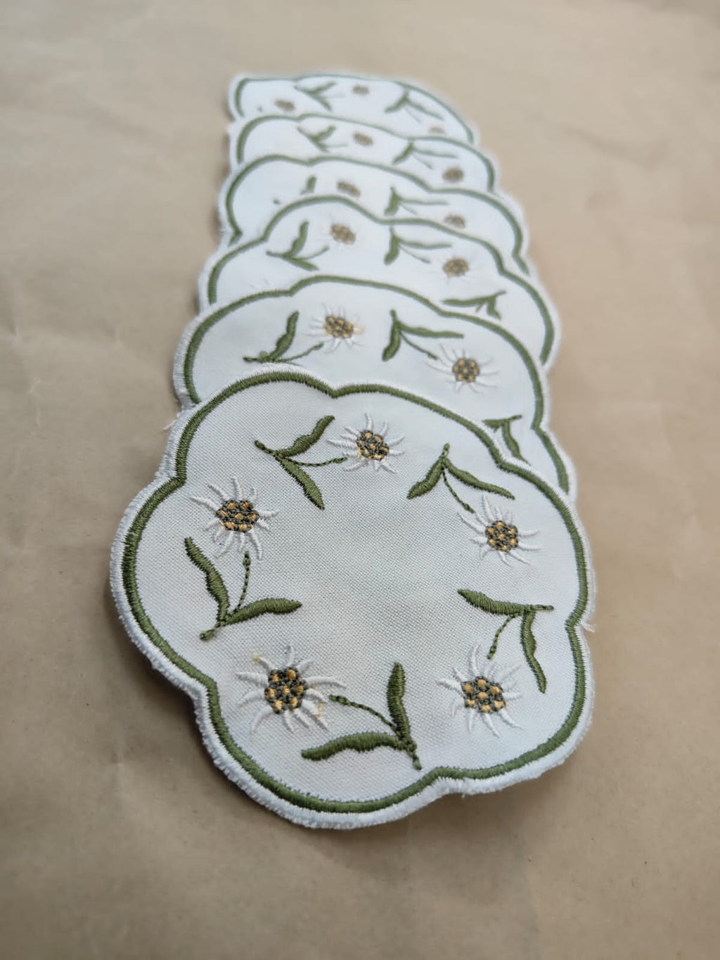 White linen round embroidered coasters.