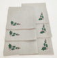 Linen christmas dinner napkins with embroidered holly leaf.