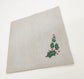 Linen christmas dinner napkins with embroidered holly leaf.