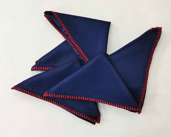 Navy blue cotton cocktail napkins with delicate embroidery.