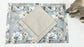 Blue linen  floral printed placemats with beige linen napkins.