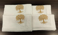White linen  dinner napkins with tree embroidery.