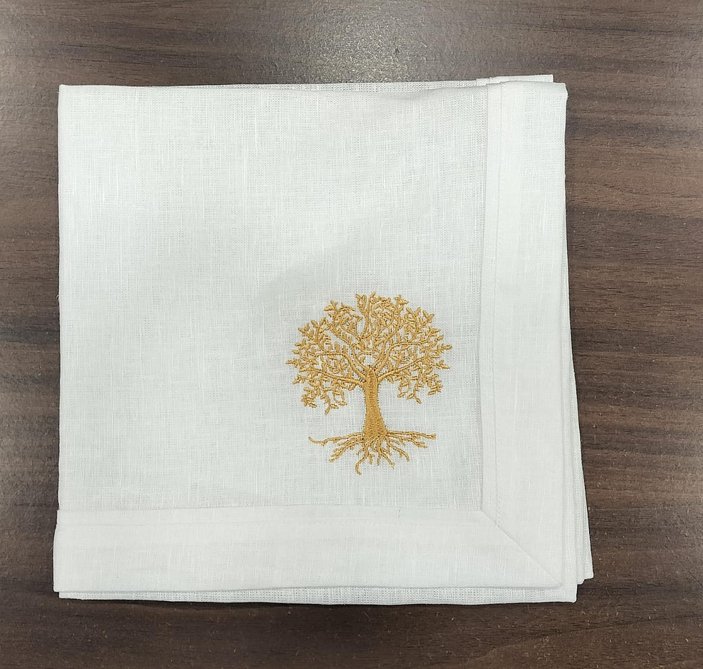 White linen  dinner napkins with tree embroidery.