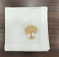 White linen  dinner napkins with tree embroidery.
