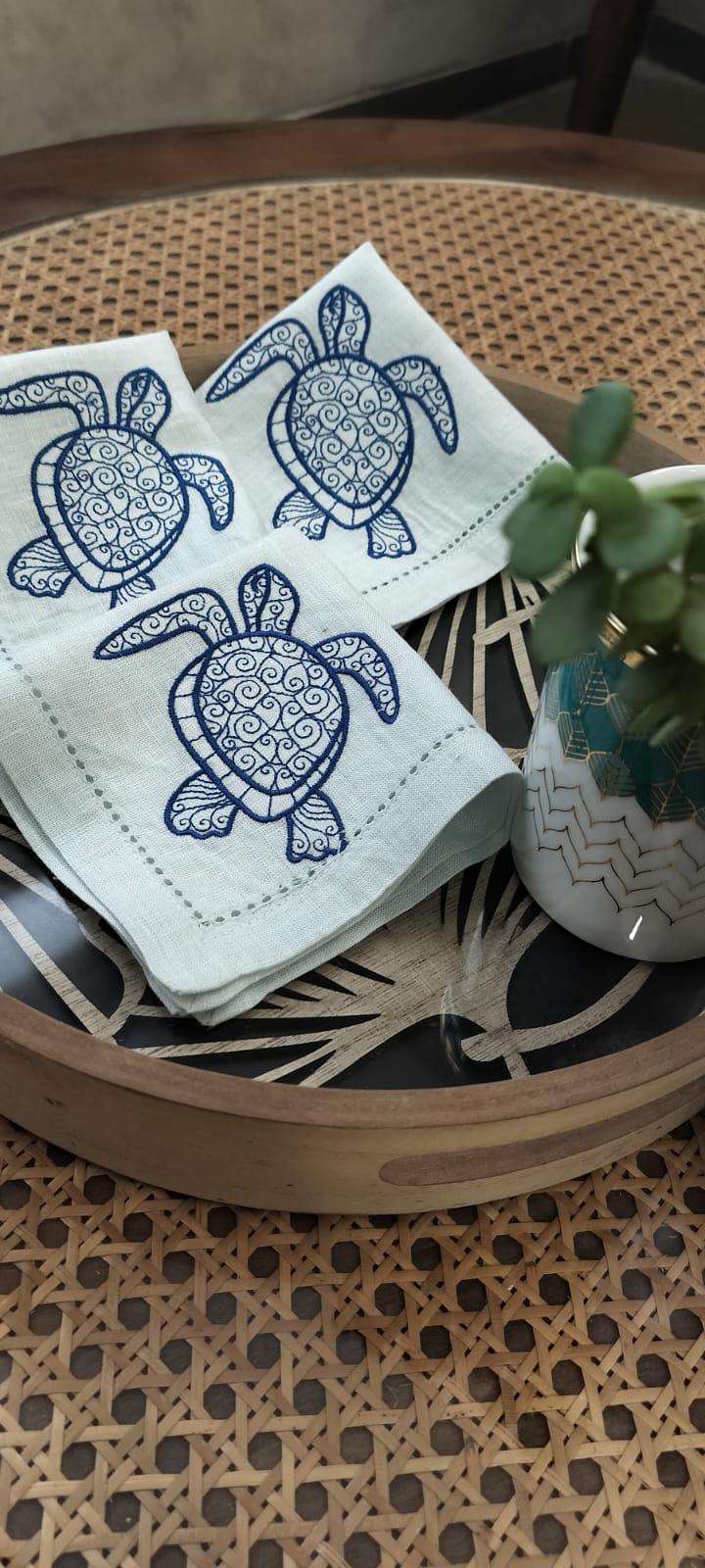 Powder blue linen cocktail napkin with embroidered turtle.
