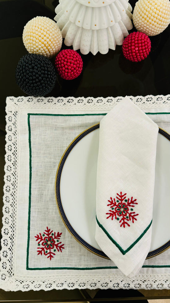 White linen placemat and napkins with snowflake embroidered.