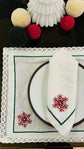 White linen placemat and napkins with snowflake embroidered.