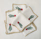 White linen cocktail napkins with christmas tree embroidered.