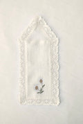 White linen  cutlery holder with floral embroidery.