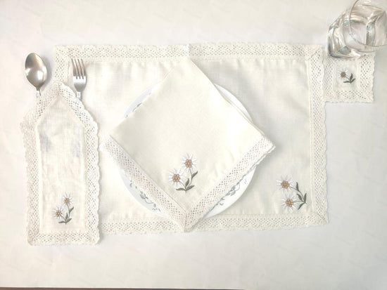 Off white linen placemats and napkins with crochet lace and embroidery.