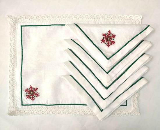 White linen placemat and napkins with snowflake embroidered.