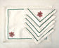 White linen placemat and napkins with snowflake embroidered.