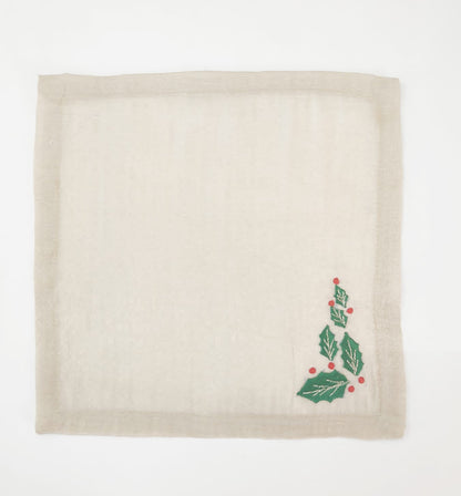 Linen christmas cocktail napkins with embroidered holly leaf.