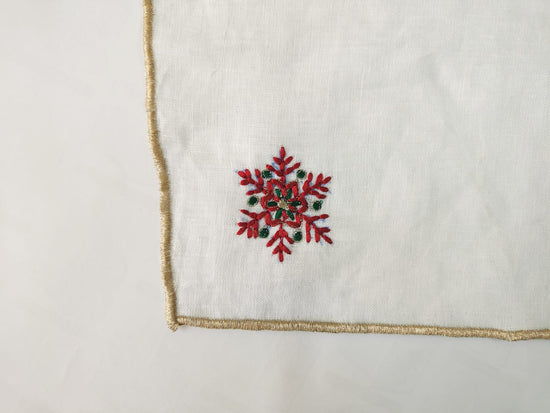 White linen cocktail napkins with snowflake embroidered.