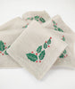 Linen christmas cocktail napkins with embroidered holly leaf.