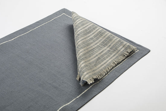 Slate blue linen placemats and striped napkins.