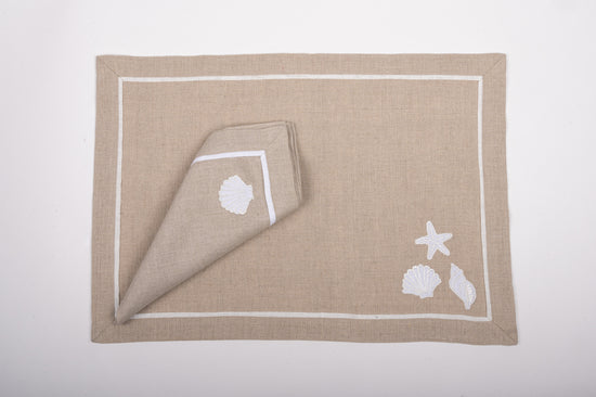 Natural coloured linen placemats  and napkins with appliqued shell embroidery.