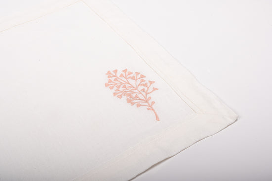 White linen placemats with  fern embroidery with pink and white striped napkins.