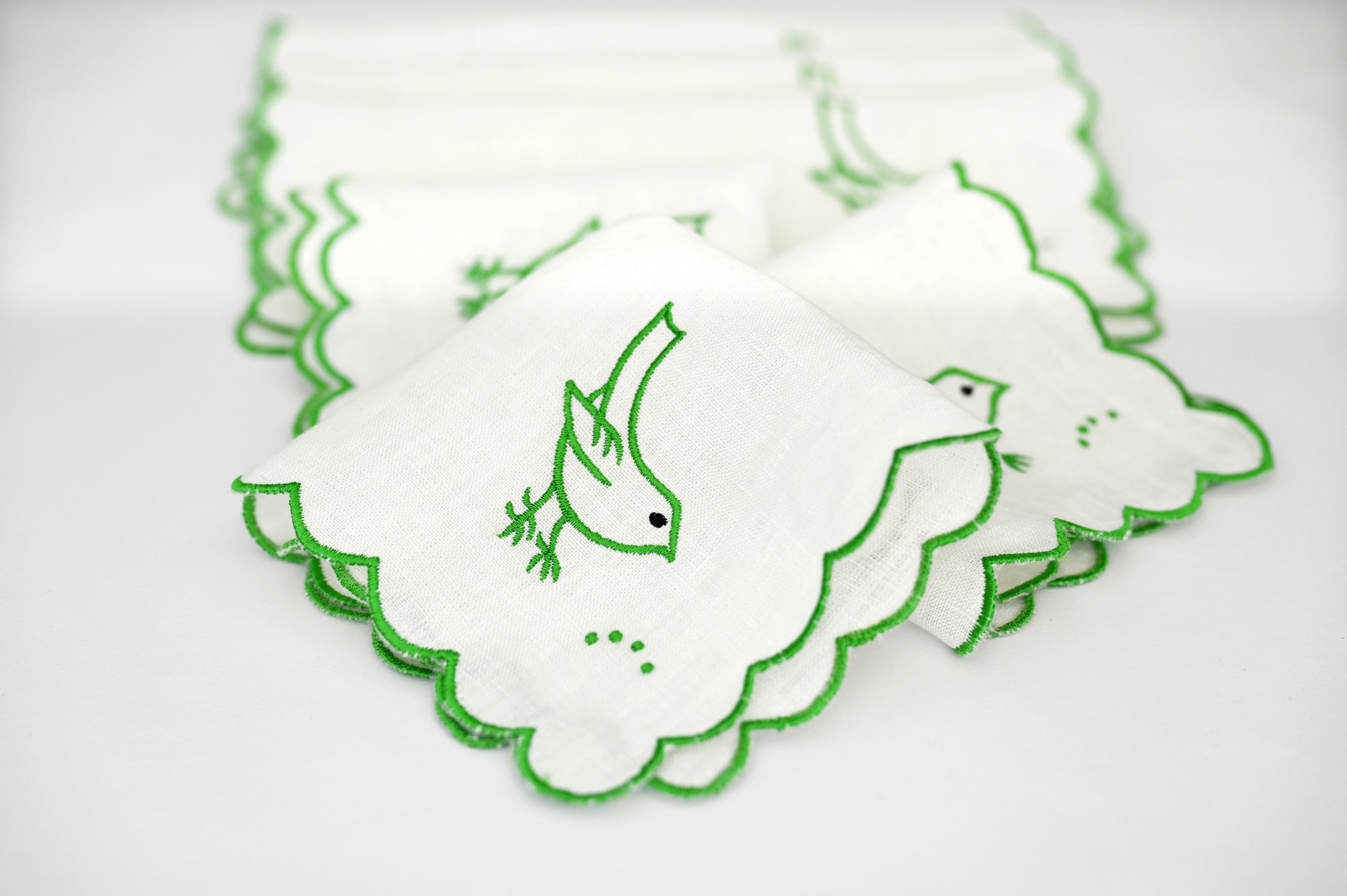 White linen cocktail napkin with bird embroidery