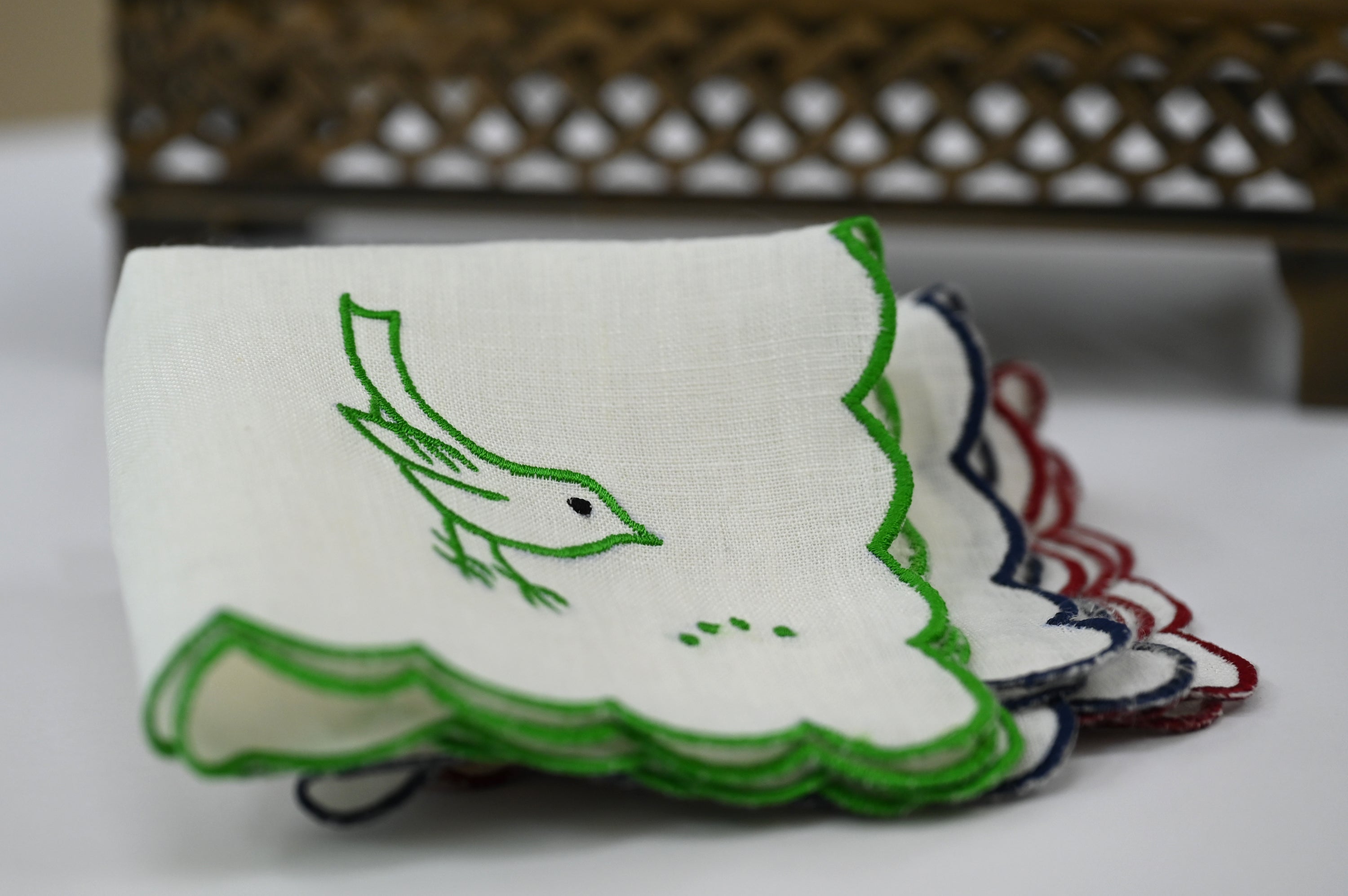 White linen cocktail napkin with bird embroidery