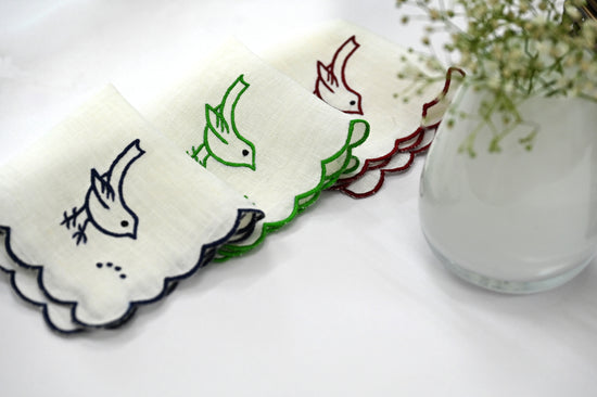 White linen cocktail napkin with bird embroidery