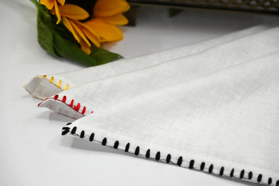 White linen embroidered cocktail napkins.