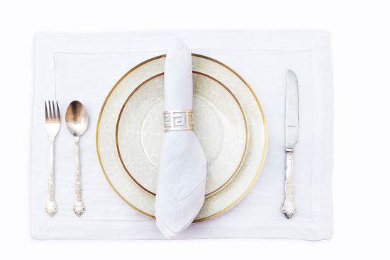 White linen  plain placemats and white linen napkins .