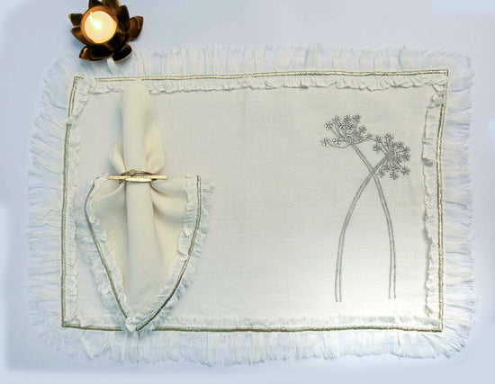 Cream linen placemats with ruffles and  embroidery with cream  linen napkins with ruffles and embroidery.