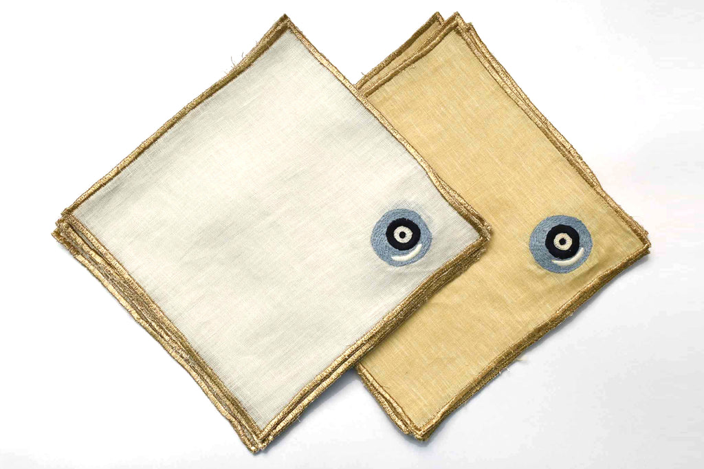 Evil eye with golden border yellow linen cocktail napkins.