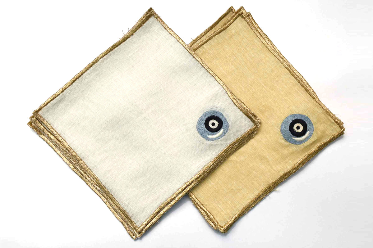 Evil eye with golden border yellow linen cocktail napkins.