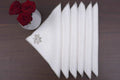 White linen cocktail napkins with gold maple leaf embroidery