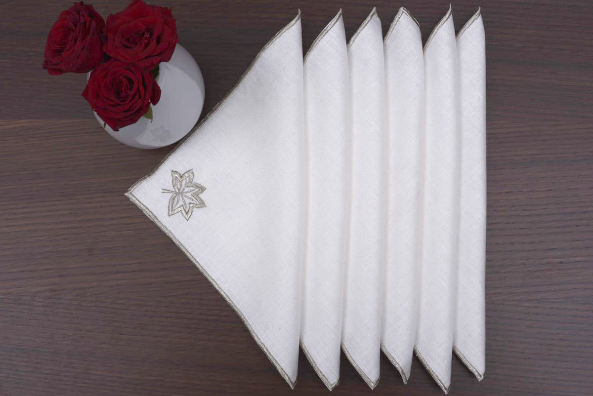 White linen cocktail napkins with gold maple leaf embroidery