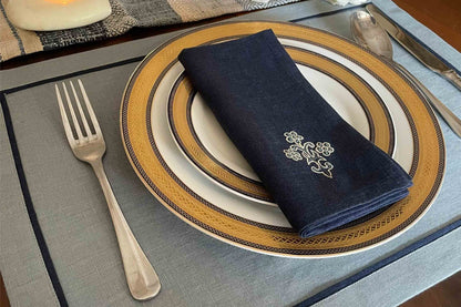 Slate blue linen placemats with navy blue embroidered napkins